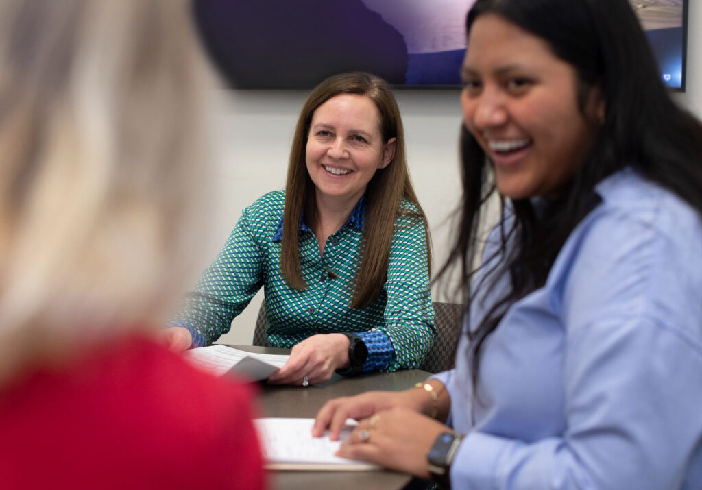 Two women assist a visitor at the Low Income Taxpayer Clinic, hosted by the Washington University in St. Louis School of Law.